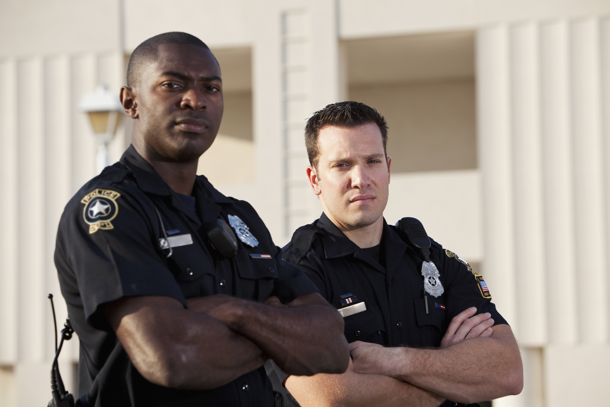 Two officers in uniform outside building
